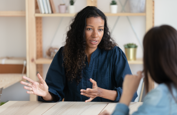 a woman talking to another woman