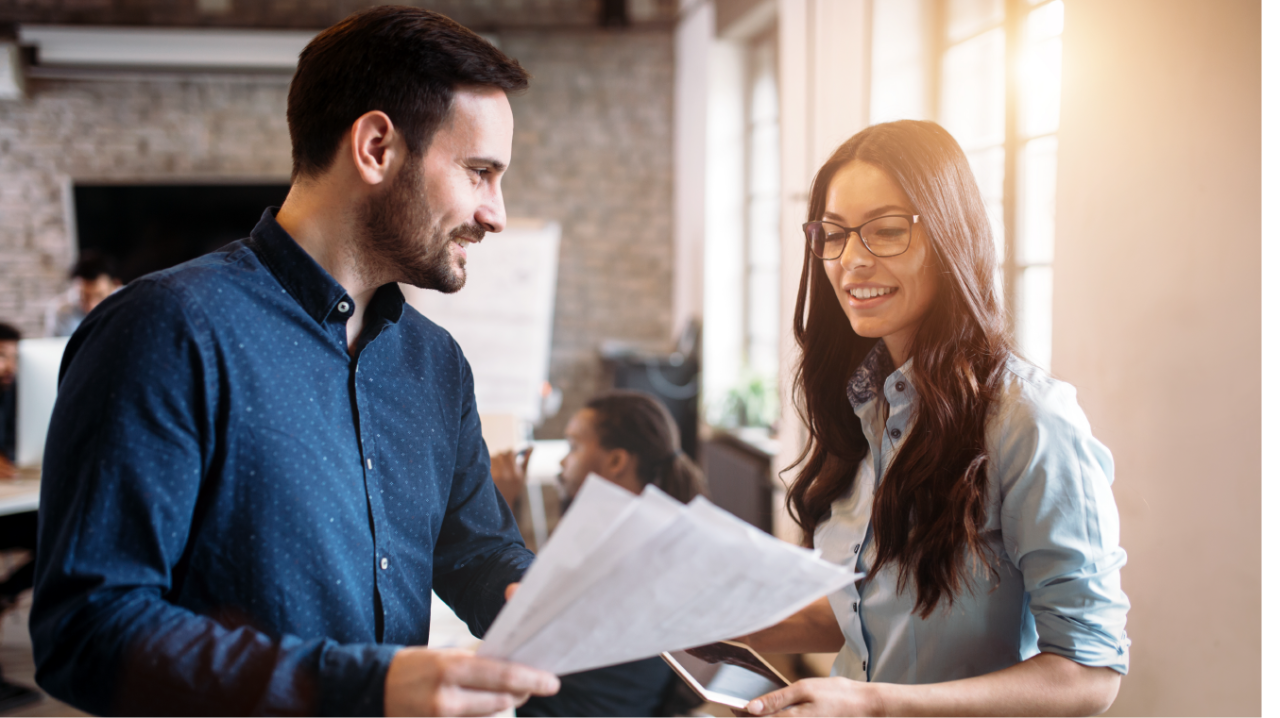 Man and a woman reading a piece of paper