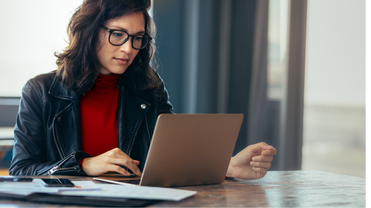 women with glasses working on a laptop
