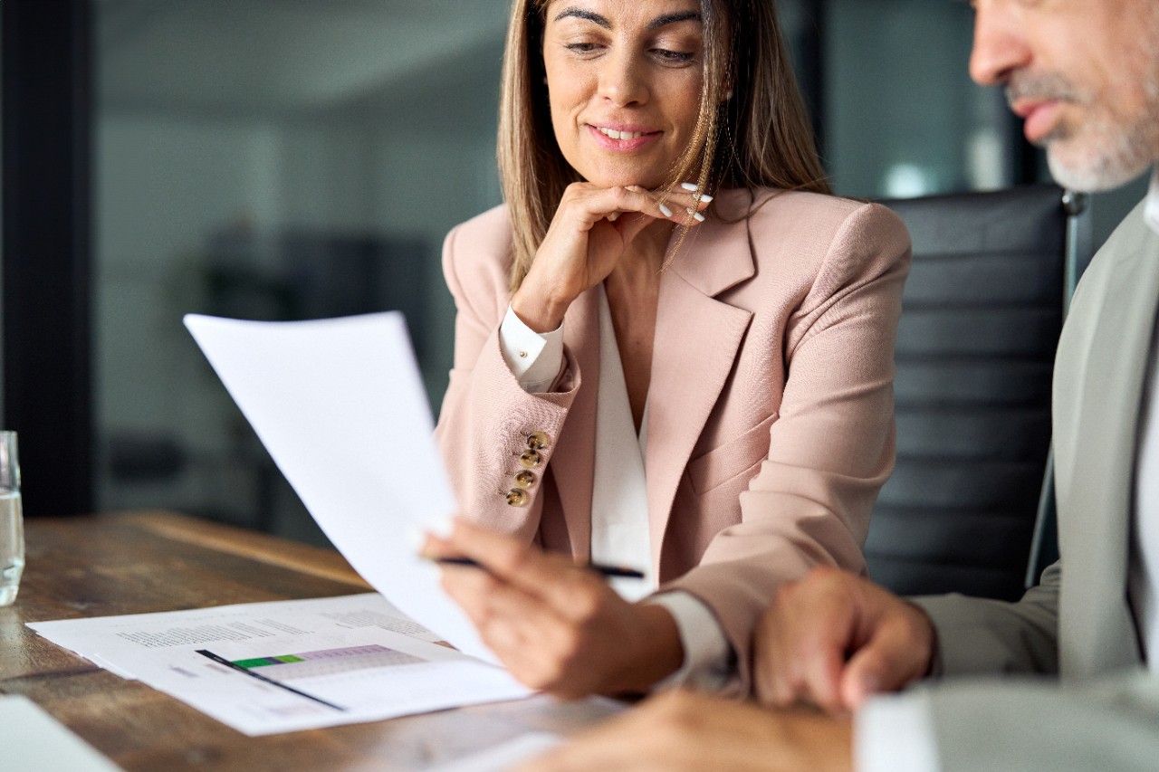 Business woman lawyer attorney showing document to man client providing advisory services, professionals discussing tax papers working in office at meeting. Legal consultancy concept. Close up.