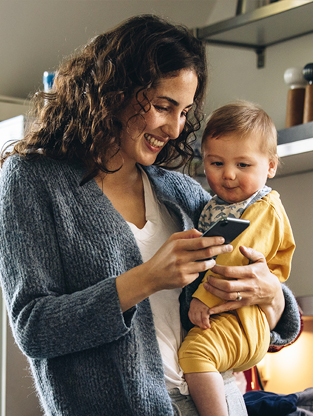 Mother with toddler speaking to family on a mobile phone