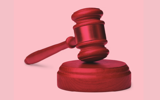 A gavel resting on a sound block.