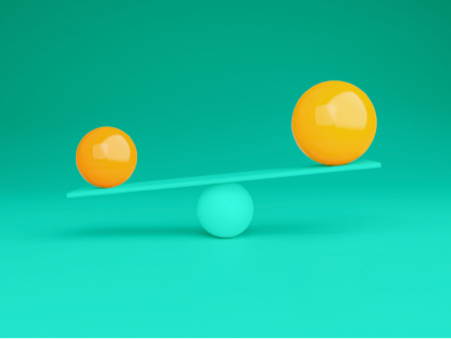 See-saw image with round objects on either end.