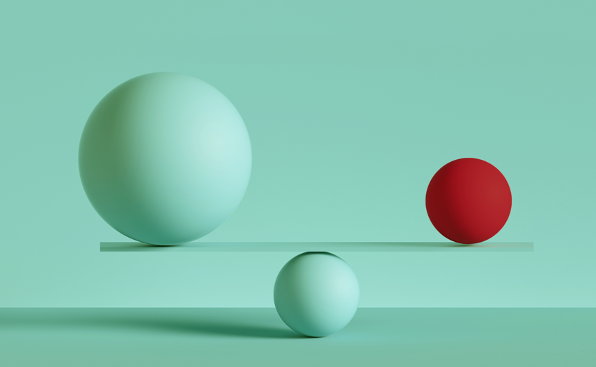 Two balls (a larger one on the left and smaller one on the right) sitting on top of a scale, representing evaluation or consideration.